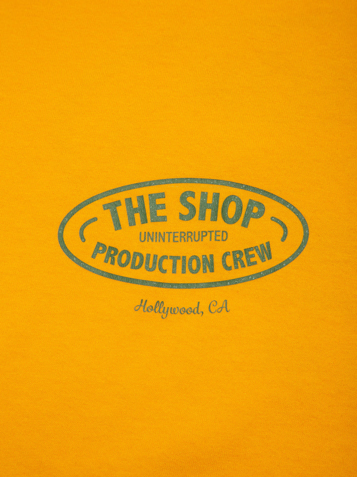 The Shop: S5E5 Crew Pocket Tee Yellow - close up of green lettering